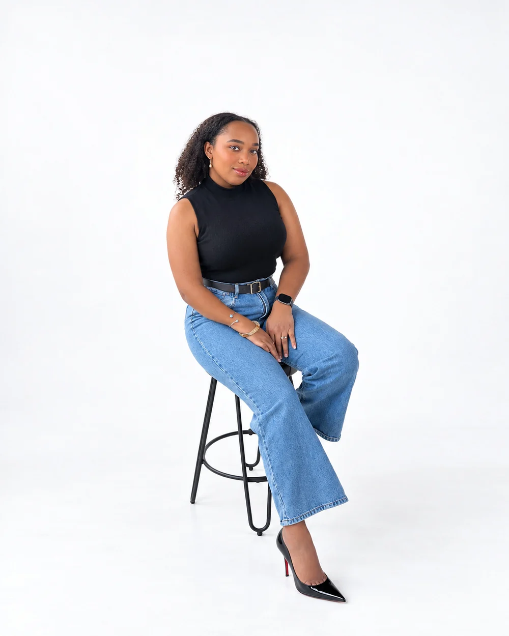 Gabrielle Maria Crawford, Esq., founder of Citrus Legal, seated on a stool